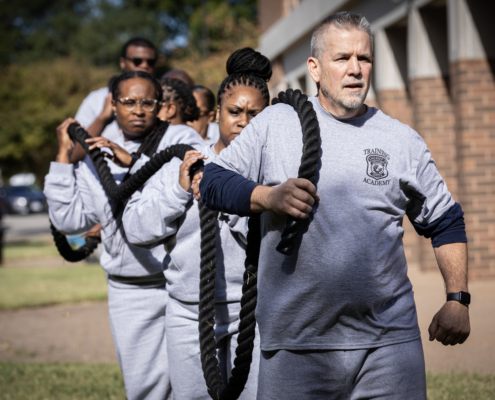 Photo of recruits working together to carry a heavy rope