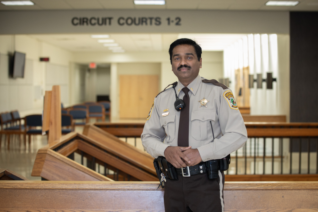 Sheriff's officer posing in front of the Circuit courts