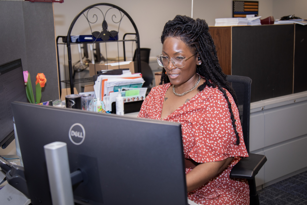 Sheriff's office civil employee working at a computer