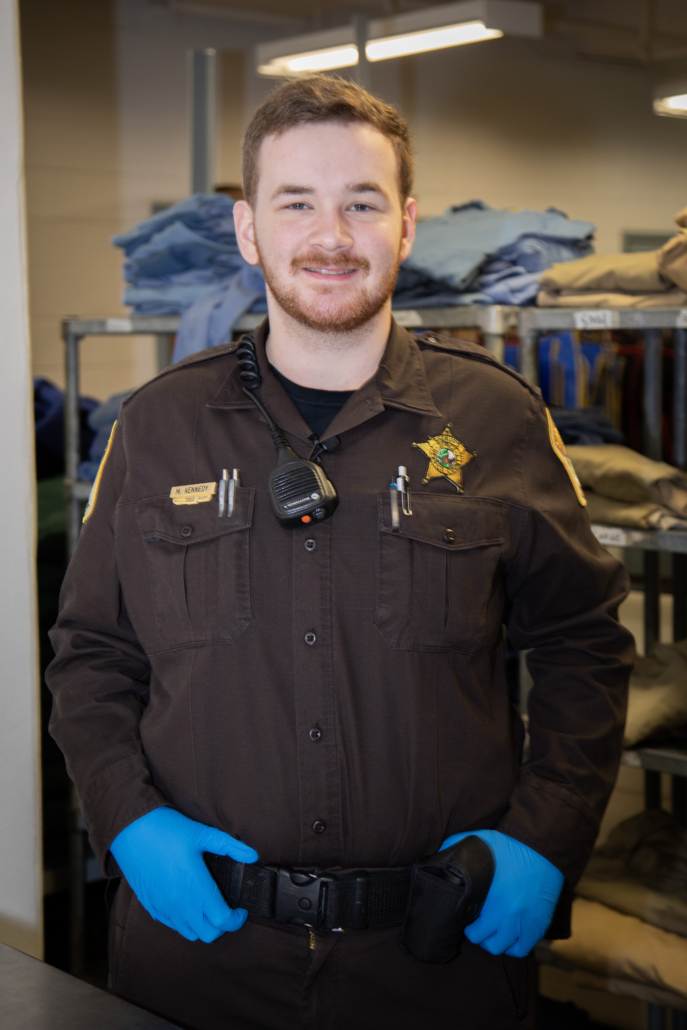 Sheriff's officer jailor facing the camera and smiling