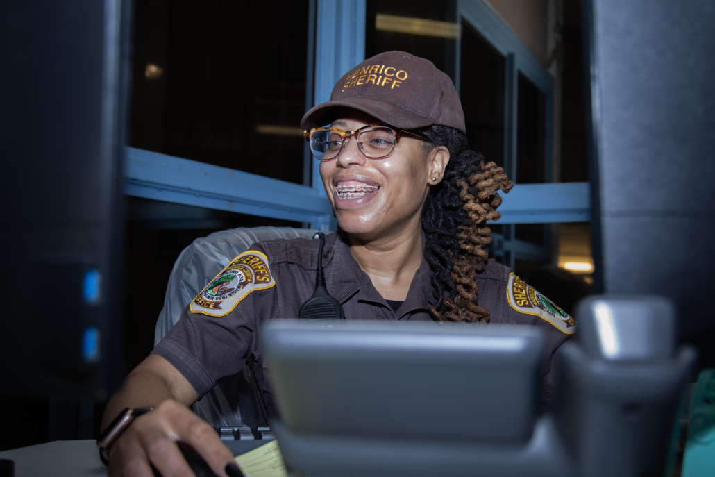 Sheriff's Officer smiling and working in an office